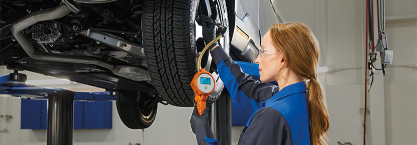 A Subaru technician checking tire pressure. | Wallace Subaru of Bristol in Bristol TN