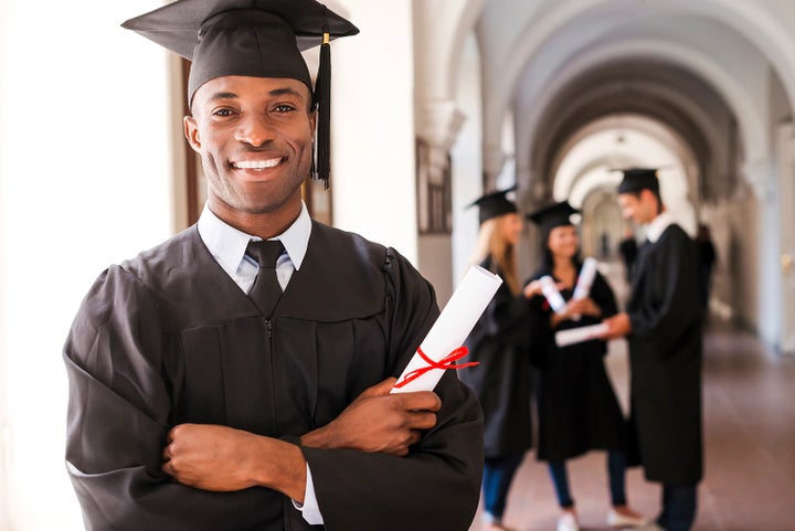 college graduate holding his diploma | Wallace Subaru of Bristol in Bristol TN