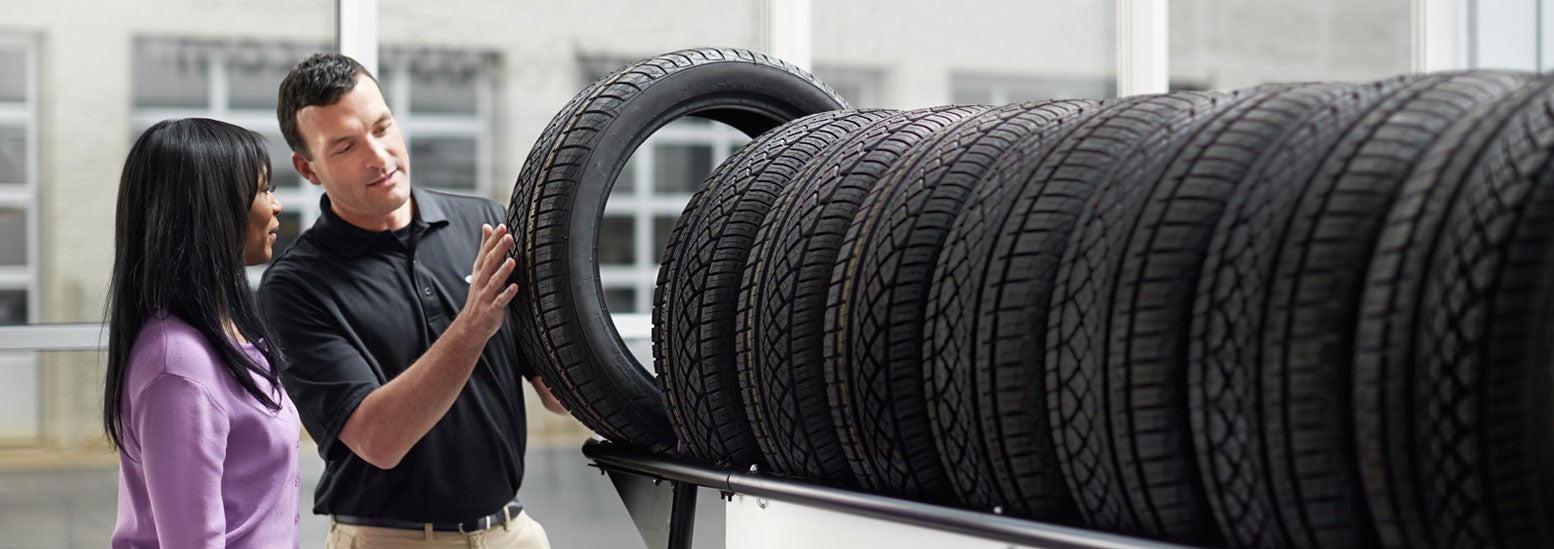 Subaru service representative showing customer a tire. | Wallace Subaru of Bristol in Bristol TN