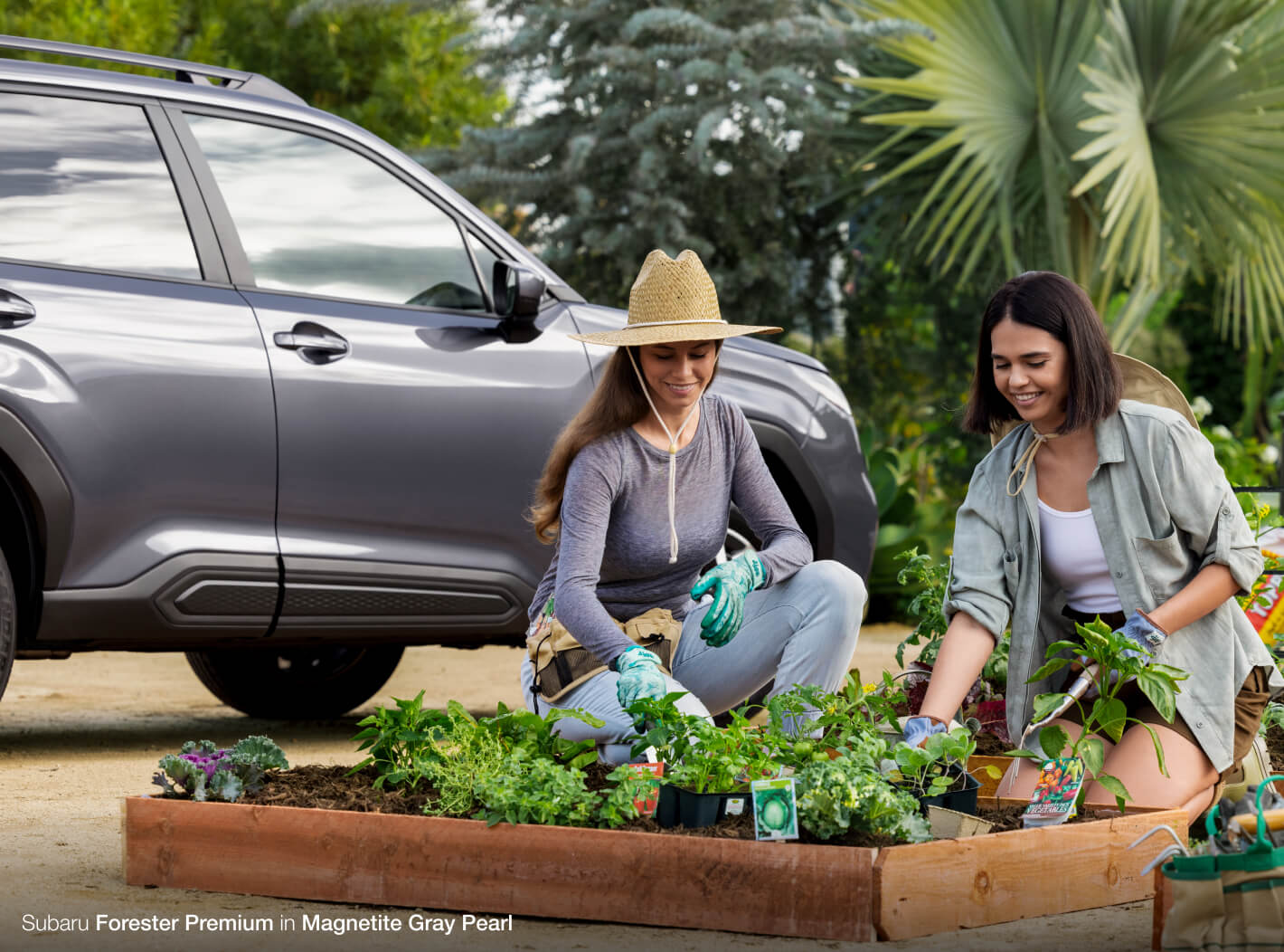 Women gardening in front of Subaru Forester Premium in Magnetite Gray Pearl